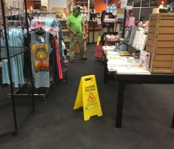 SERVPRO techs in retail store with a wet floor