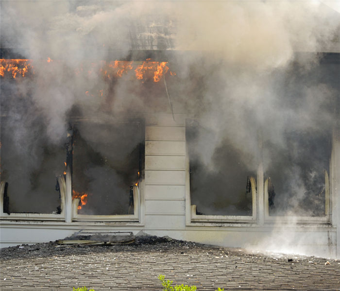 smoke and fire coming out of the windows of a house