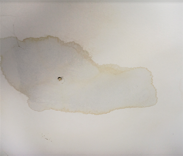 a water damaged white wall with watermarks on it